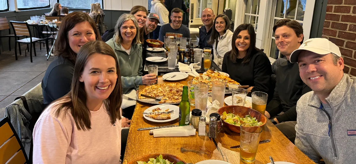 Group of attendees enjoying dinner together at a restaurant